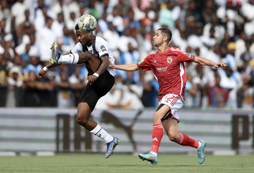 Phillippe Kinzumbi of TP Mazembe challenged by Reda Slim of Al Ahly during the CAF Champions League 2023/24 1st leg semifinal match between TP Mazembe and Al Ahly at Stade TP Mazembe in Lubumbashi, DRC on 20 April 2024