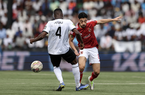 Akram Tawfik of Al Ahly challenged by Johnson Atibu Radjabu of TP Mazembe during the CAF Champions League 2023/24 1st leg semifinal match between TP Mazembe and Al Ahly at Stade TP Mazembe in Lubumbashi, DRC on 20 April 2024