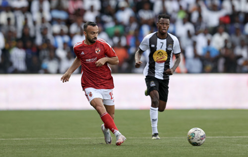 Mohamed Magdy Afsha of Al Ahly challenged by Phillippe Kinzumbi of TP Mazembe  during the CAF Champions League 2023/24 1st leg semifinal match between TP Mazembe and Al Ahly at Stade TP Mazembe in Lubumbashi, DRC on 20 April 2024