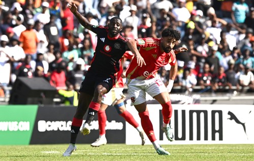Deon Hotto of Orlando Pirates challenges Marawan Attia Fathom Ghallab of Al Ahly during the CAF Champions League 2024/25 match between Orlando Pirates and Al Ahly